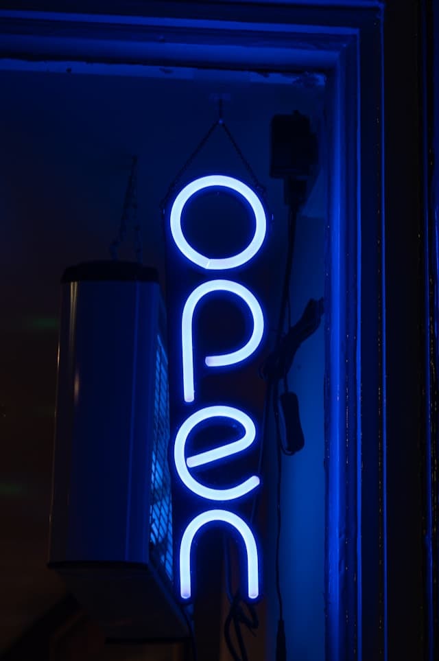 Blue neon open sign at venue